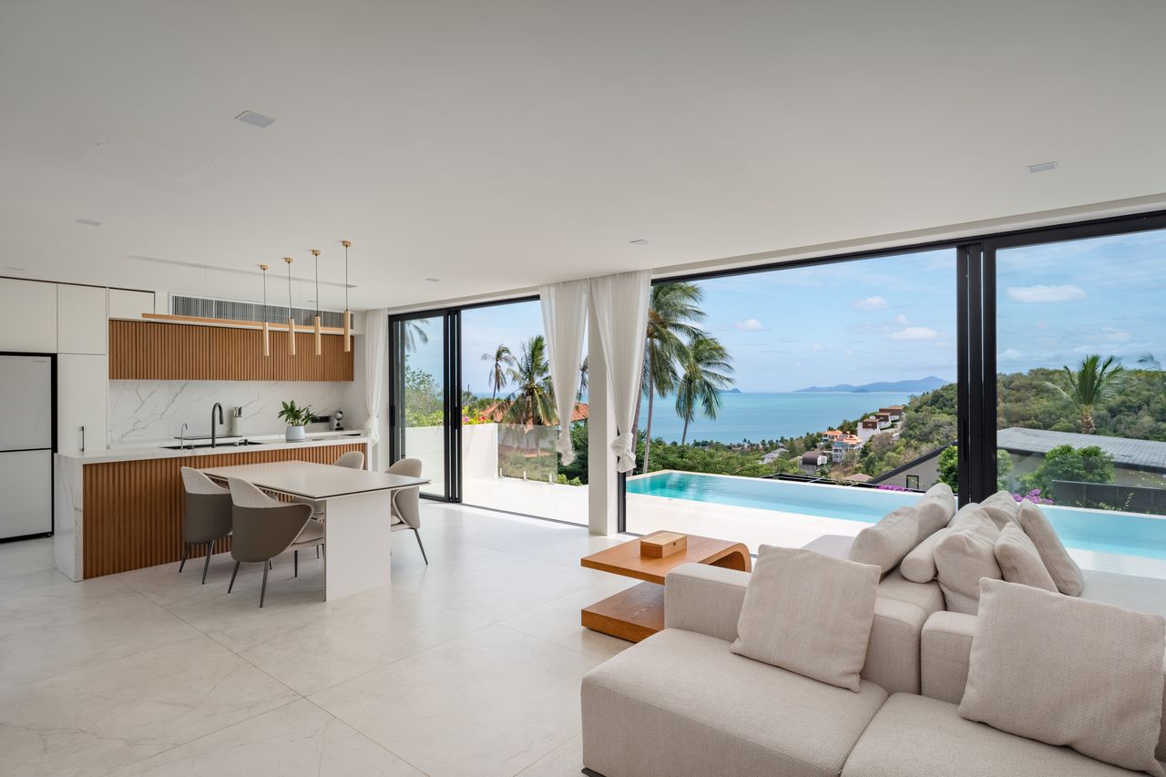 Open living room and kitchen opening onto the pool