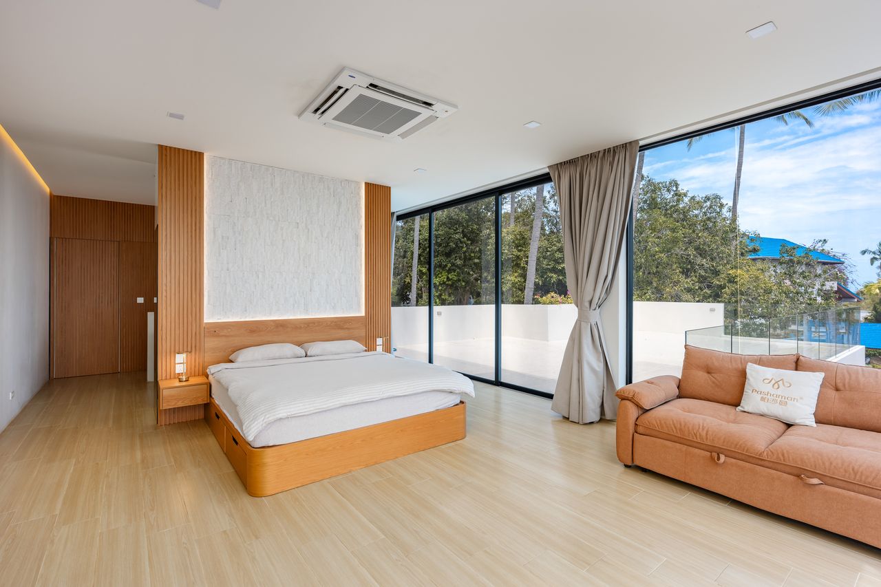 Master bedroom with sofa and terrace
