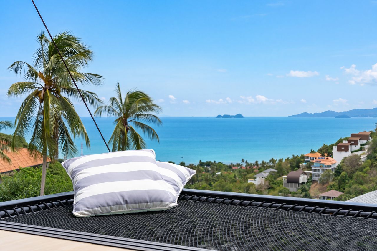 Lounging net with cushions and a view over the sea