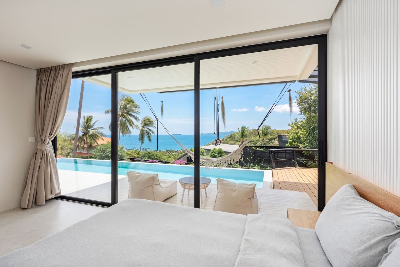 Bedroom looking out to the pool and sea